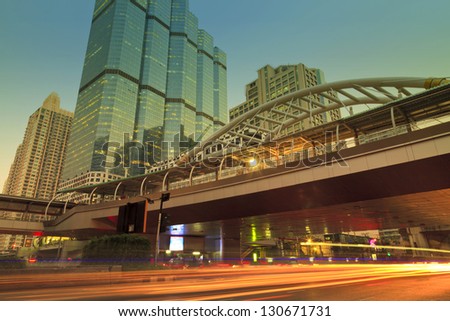 The light trails of the cars in the city on the modern building background in Bangkok Thailand