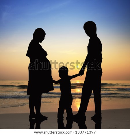 Silhouettes of Happy family the concept of parents and son with beach at sunset