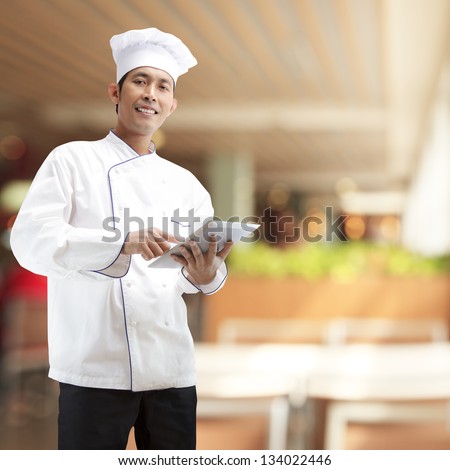 Chef using digital tablet in restaurants