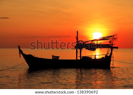 Silhouette of fishing boat at sunset