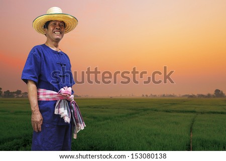 Happy farmer with rice fields at sunrise