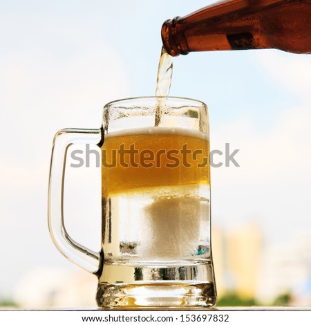 Pouring beer into mug from the bottle