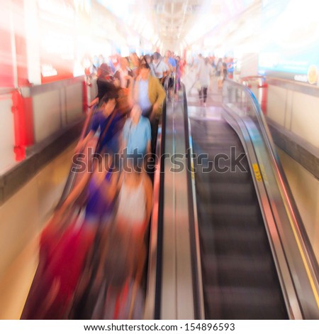 City people walking in sky train station in motion blur