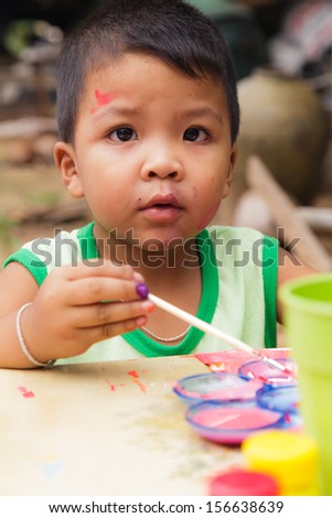 Asian boy in countryside thailand. painting in outdoors