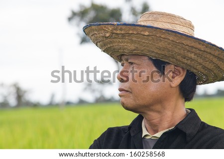 Old Balinese Farmer With Wrinkled Face In Traditional Straw Hat