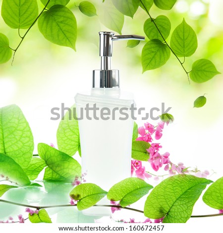 White pump bottle on green leaves