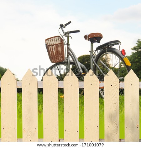 White fences in the garden with bicycles