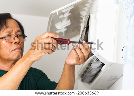 man repair air conditioner