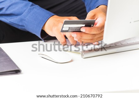 Businessman typing and making on-line payment with credit card