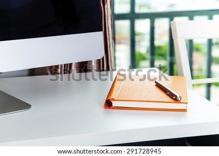 Notebook on the table with Computer on Home Office