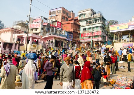 VARANASI, INDIA -  29 JANUARY: People crowd along the Ghats on 29 January 2013 in Varanasi. Varanasi is a major destination for pilgrims and tourists alike.