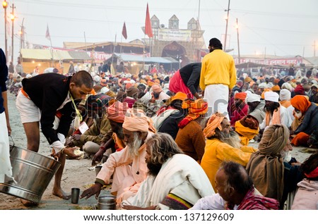 ALLAHBAD, INDIA - 28 JANUARY: Feeding of the Babas (holy-men) at the Kumbh Mela religious festival on 28 January 2013 in Allahbad. In 2013 it is estimated that 100 million people attended Kumbh Mela.