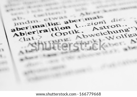 Aberration - text and explanation in German language, shot from a different angle/Aberration