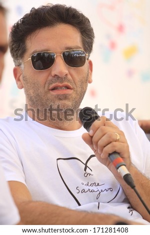 SARAJEVO - AUGUST 17: The Oscar winner Danis Tanovic gives an interview at the opening ceremony of the 19th Sarajevo Film Festival on August 17, 2013 in Sarajevo.