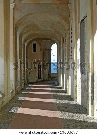 Collonade with shadows of columns in old villa, Italy