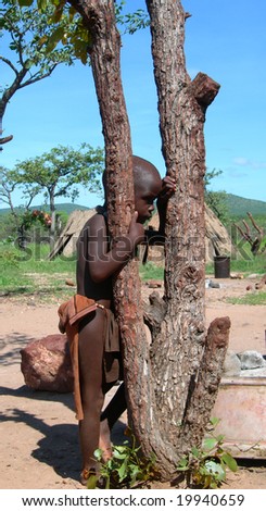 Young boy in traditional tribe village in the Kalahari desert, Namibia