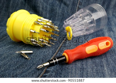 A screwdriver and bits on a fabric