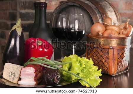 Still life with wine,some vegetables, cheese and ham.