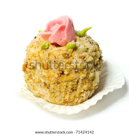 Cake with nuts, decorated with rosettes. Isolated on white background.