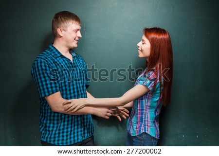 Young man and woman fight for fun, they happily smiling.