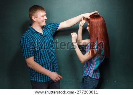 Young man and woman fight for fun, they happily smiling.