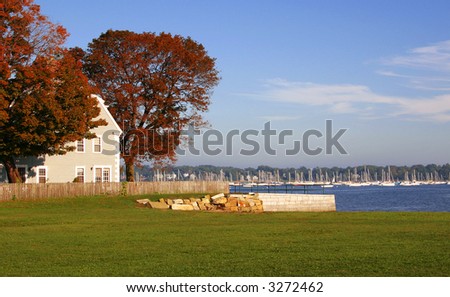 New England harbor with sailboats in autumn