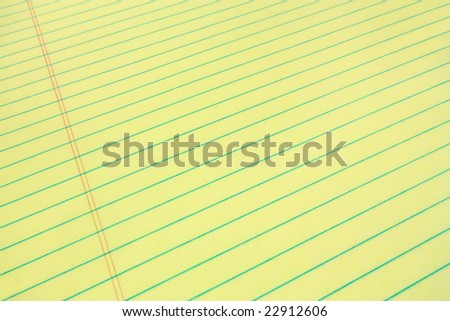 Legal pad of yellow paper for your business message, wide angle view