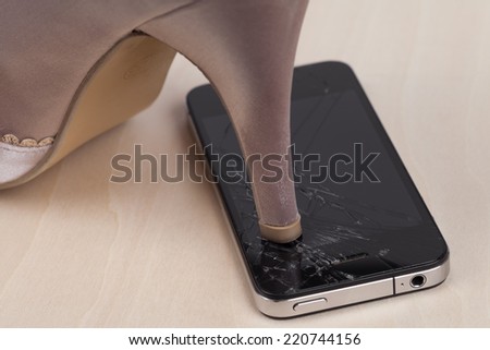 High heel step on broken screen smartphone