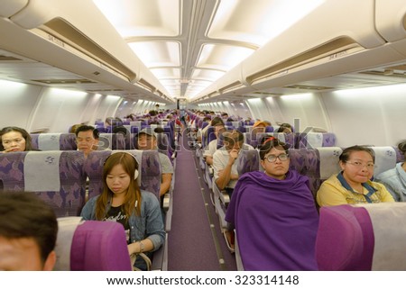 BANGKOK, THAILAND - OCTOBER 1: flight crew and passengers on board an Thai Airways flight from Suvarnabhumi Airport to Yangoon Airport on October 1, 2015