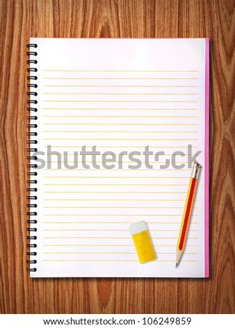 Blank white notebook on wood background. drop your text on the space