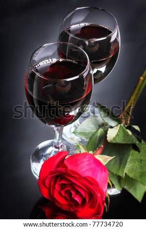 Two goblet of wine with one rose