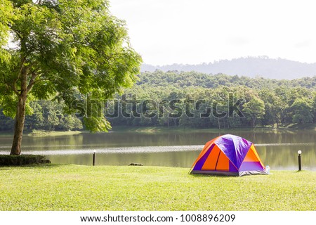 Tourist dome tent camping at lake side  in forest camping site