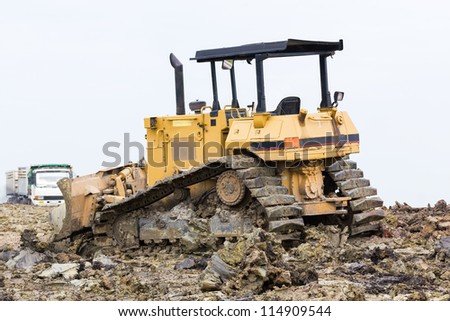 Bulldozer machine doing earth moving work in construction site