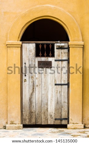 Closed door wooden covered with wrought iron of old building