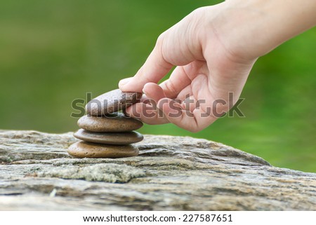 Zen concept, Hand put stone building a pile of zen stones