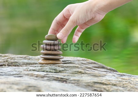Zen concept, Hand put stone building a pile of zen stones