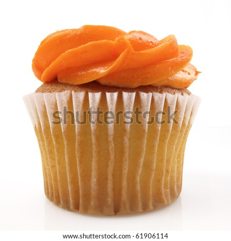 stock photo Single yellow cupcake with orange icing on white