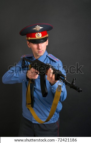 police officer in uniform with machine gun  AK-47