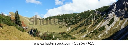 Hike on the Saalfeld-High-Mountain-Trail in Tyrol, Austria at a sunny autumn day, peaks of the Tannheim Mountains, mountain meadows and a mountain trail, panorama/The AllgÃ?Â¤u Alps in autumn