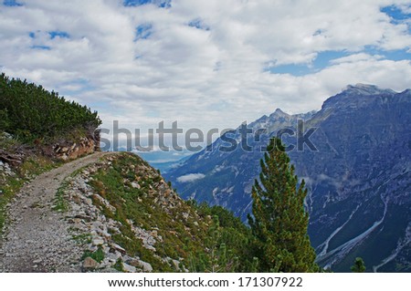 Hiking in the Stubai Alps in Tyrol; narrow mountain path in the high mountains/Mountain path in the high mountains