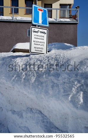 reserved parking in the winter; a sign in a snow wall Reserved parking in the winter