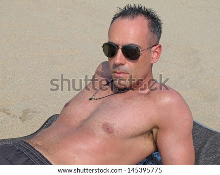 Man sunbathing on the beach