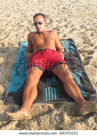 man sunbathing on the beach