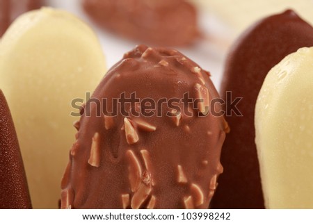 Closeup of almond, chocolate and white chocolate popsicles