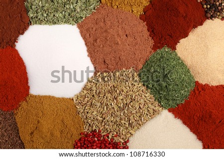 Colorful spices like pepper, paprika, curry and caraway form a background