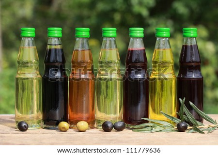 Different types of cooking oil in small bottles on a wooden table