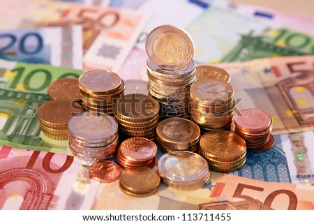 A stack of Euro coins and notes