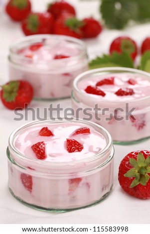 Strawberry yogurt served with fresh strawberries in small glasses
