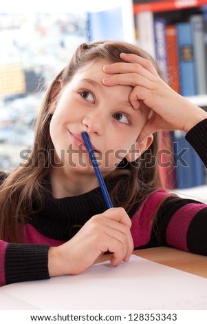 Little girl has a good idea while doing her homework
