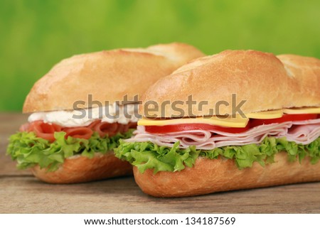 Sub Sandwiches with ham, salmon, cheese, tomatoes and lettuce